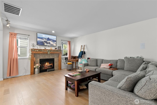 6974 Prism St SE, Lacey, WA 98513 - living area with light wood-type flooring, a tile fireplace, and recessed lighting