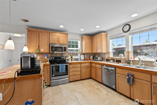 6974 Prism St SE, Lacey, WA 98513 - kitchen featuring appliances with stainless steel finishes, plenty of natural light, decorative backsplash, and recessed lighting