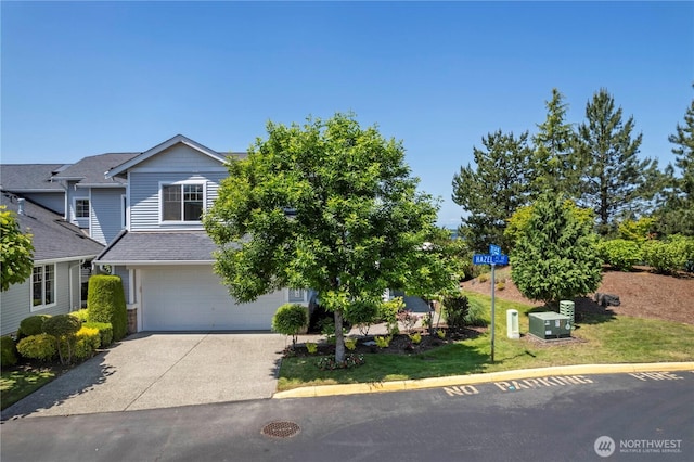 7103 Hazel Pl SE, Auburn, WA 98092 - obstructed view of property with a garage and concrete driveway