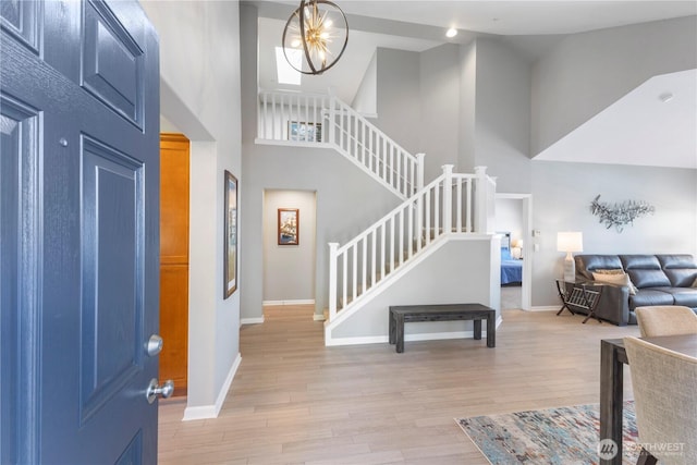 7103 Hazel Pl SE, Auburn, WA 98092 - foyer entrance featuring high vaulted ceiling, stairway, and light wood-style flooring