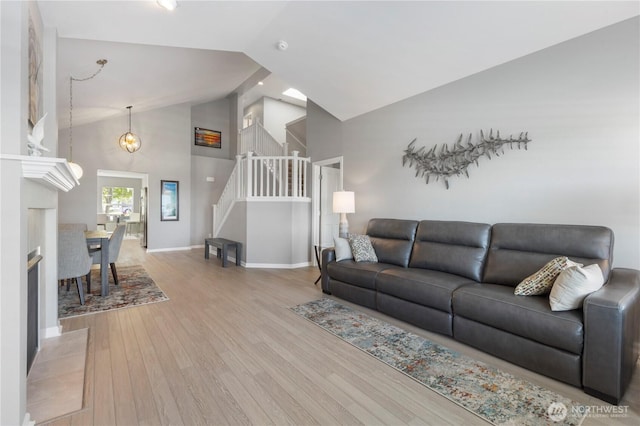 7103 Hazel Pl SE, Auburn, WA 98092 - living area featuring wood finished floors, stairway, and high vaulted ceiling