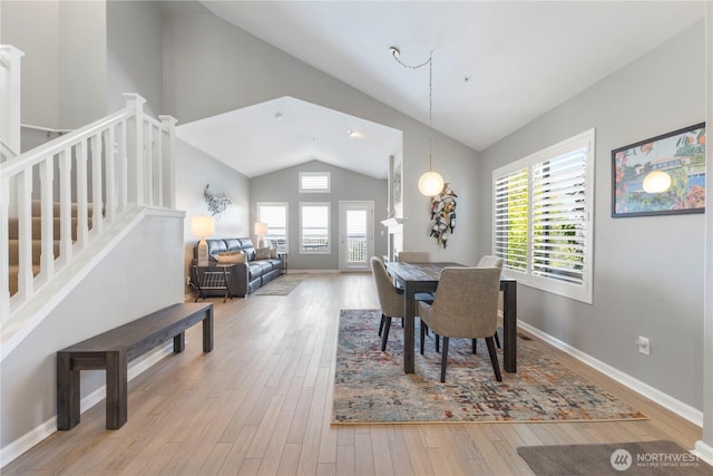 7103 Hazel Pl SE, Auburn, WA 98092 - dining space with lofted ceiling, stairs, and wood finished floors