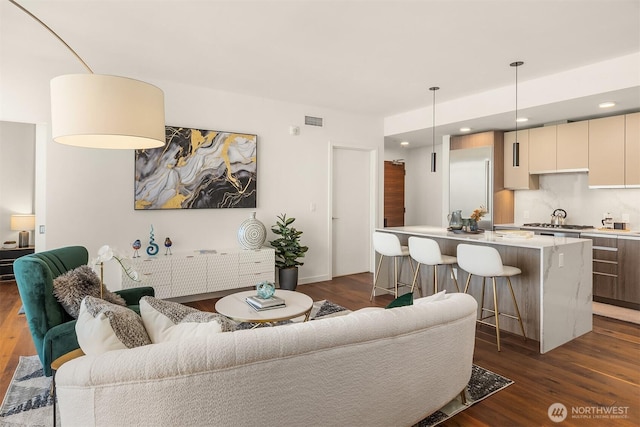 800 Columbia St Unit 2309, Seattle, WA 98104 - living area featuring dark wood finished floors and recessed lighting