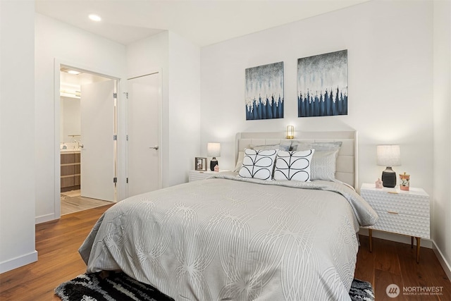 800 Columbia St Unit 2309, Seattle, WA 98104 - bedroom with wood finished floors, recessed lighting, and connected bathroom