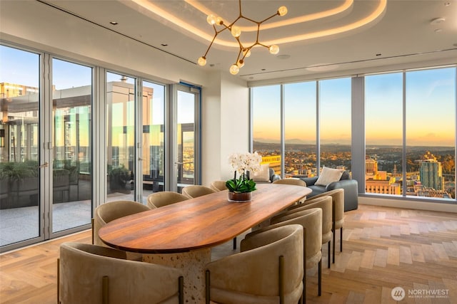 800 Columbia St Unit 2309, Seattle, WA 98104 - dining space featuring a raised ceiling and a chandelier