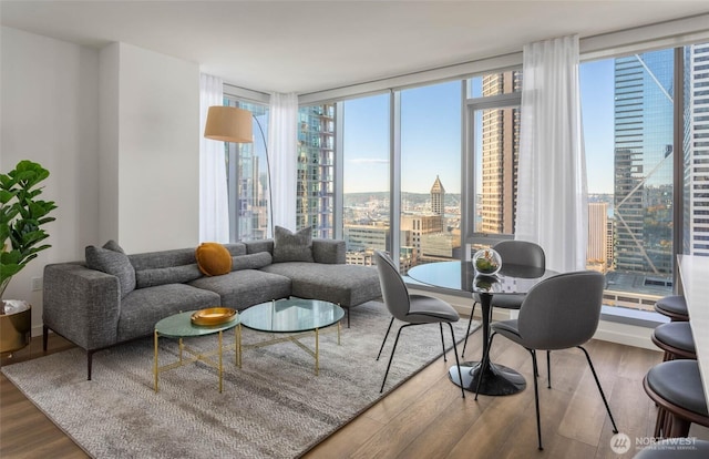 800 Columbia St Unit 2503, Seattle, WA 98104 - living room with wood finished floors, a view of city, plenty of natural light, and a wall of windows