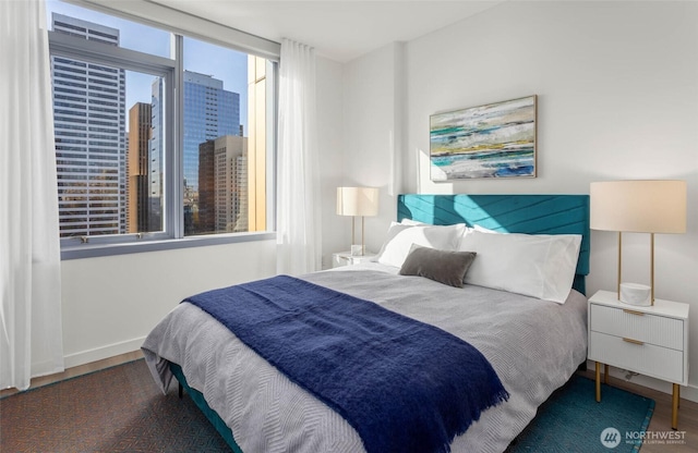 800 Columbia St Unit 2503, Seattle, WA 98104 - bedroom featuring wood finished floors and baseboards