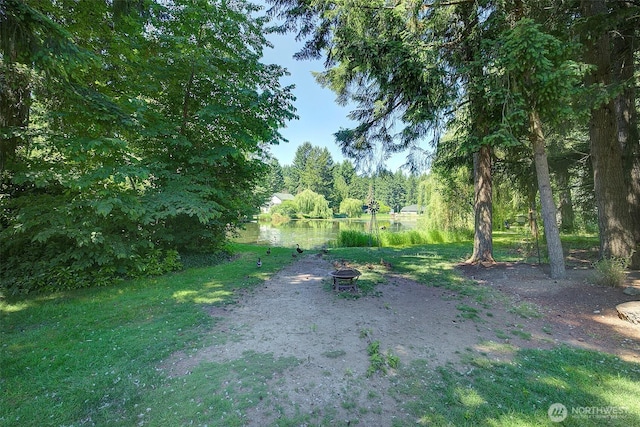 12118 261st Ave E, Buckley, WA 98321 - view of green lawn featuring a fire pit and a water view
