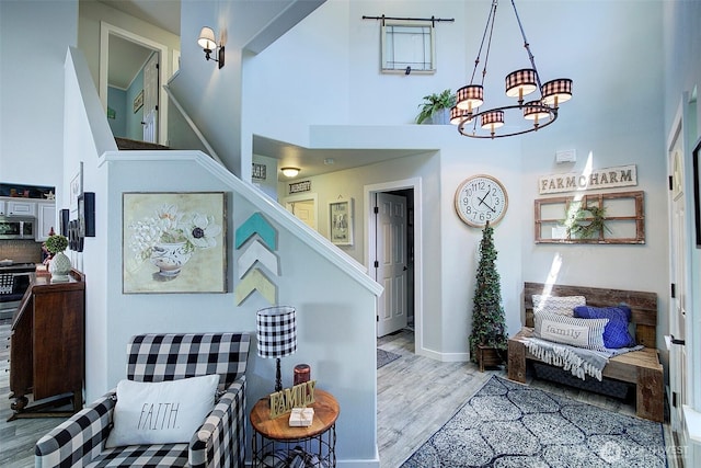 12118 261st Ave E, Buckley, WA 98321 - stairway featuring a towering ceiling, wood finished floors, and a chandelier