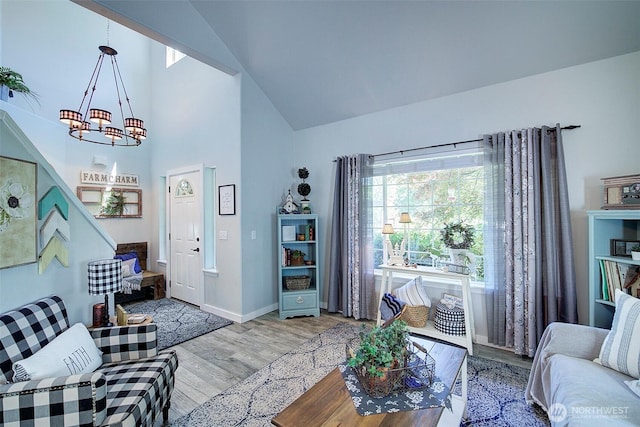 12118 261st Ave E, Buckley, WA 98321 - living room featuring wood finished floors, a chandelier, and high vaulted ceiling