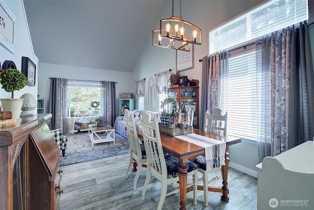 12118 261st Ave E, Buckley, WA 98321 - dining area featuring a chandelier, high vaulted ceiling, and wood finished floors