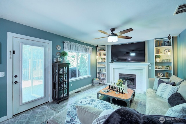12118 261st Ave E, Buckley, WA 98321 - living area with a fireplace, a ceiling fan, and wood finished floors