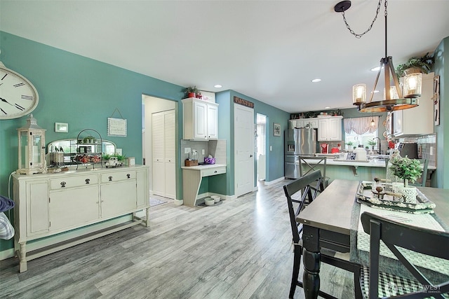 12118 261st Ave E, Buckley, WA 98321 - dining space featuring light wood-style floors, recessed lighting, and a chandelier