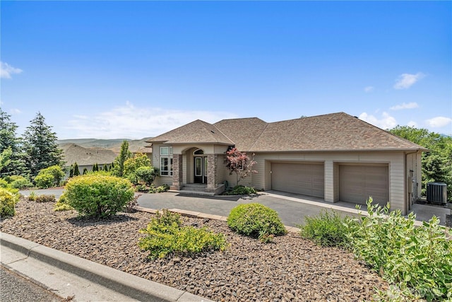 1075 Ridge Crest Dr, Wenatchee, WA 98801 - view of front of house with a garage, driveway, and a shingled roof