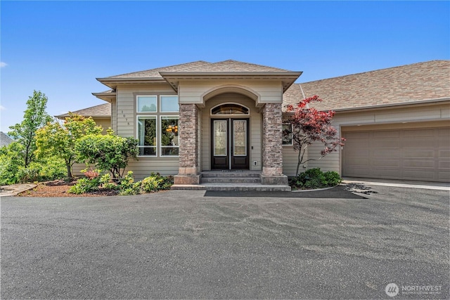 1075 Ridge Crest Dr, Wenatchee, WA 98801 - entrance to property with driveway, a shingled roof, and a garage