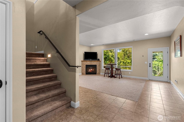 1075 Ridge Crest Dr, Wenatchee, WA 98801 - stairs with tile patterned flooring, a fireplace with flush hearth, and recessed lighting