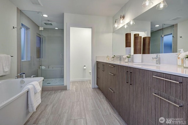 8707 116th Ave NE Unit A, Kirkland, WA 98033 - full bathroom featuring a stall shower, vanity, and a tub to relax in