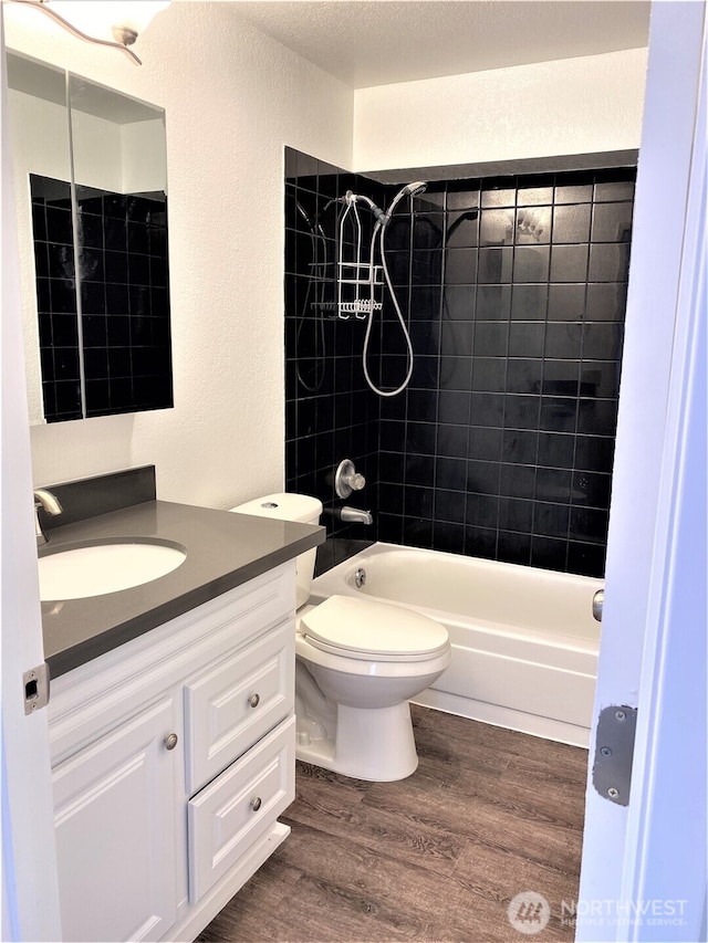 6003 Broadway, Everett, WA 98203 - full bath with vanity, wood finished floors,  shower combination, and a textured wall