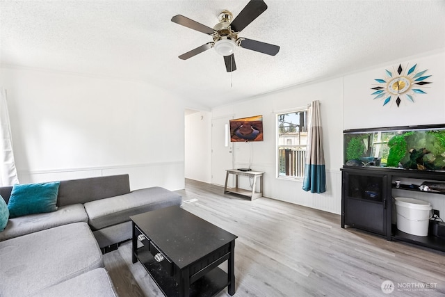 1921 208th St E Unit 7, Spanaway, WA 98387 - living area with ceiling fan, vaulted ceiling, wood finished floors, and a textured ceiling