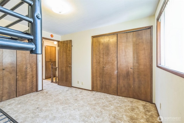 238 NE Damson Pl, College Place, WA 99324 - unfurnished bedroom featuring a closet, carpet flooring, and multiple windows
