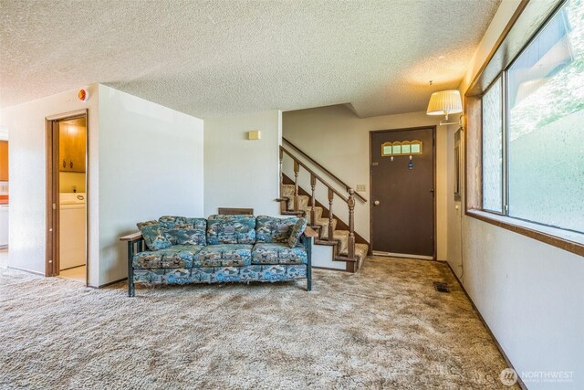 238 NE Damson Pl, College Place, WA 99324 - living room featuring a textured ceiling, carpet, and stairs