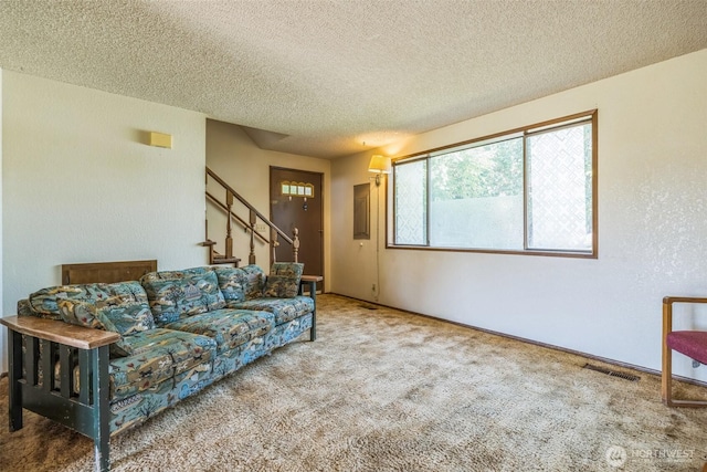 238 NE Damson Pl, College Place, WA 99324 - carpeted living room with a textured ceiling and stairway