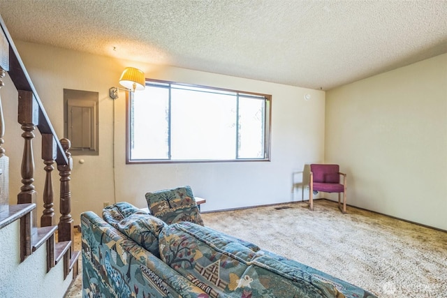238 NE Damson Pl, College Place, WA 99324 - carpeted living area with stairway and a textured ceiling