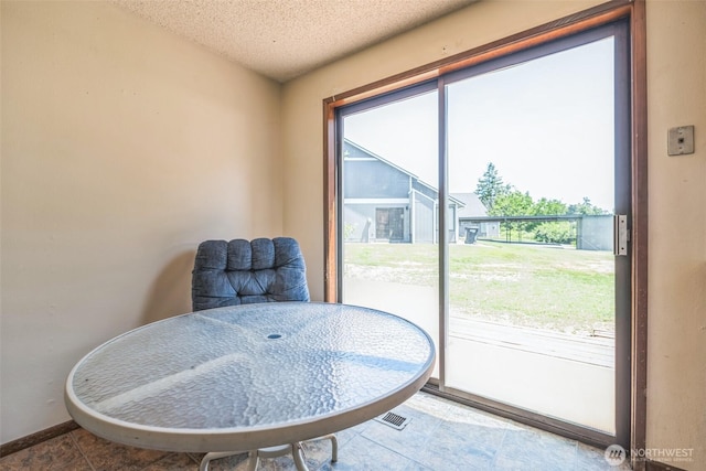 238 NE Damson Pl, College Place, WA 99324 - living area featuring a textured ceiling and tile patterned floors
