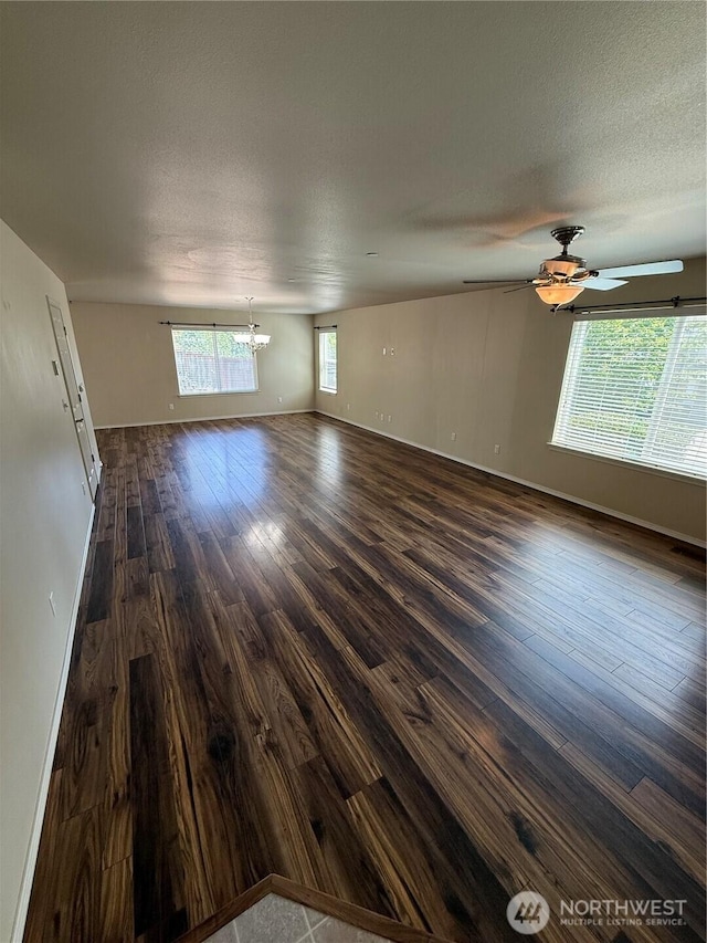 1306 Brackenridge Ave, Dupont, WA 98327 - unfurnished room featuring a chandelier, dark wood-style flooring, a ceiling fan, and a textured ceiling