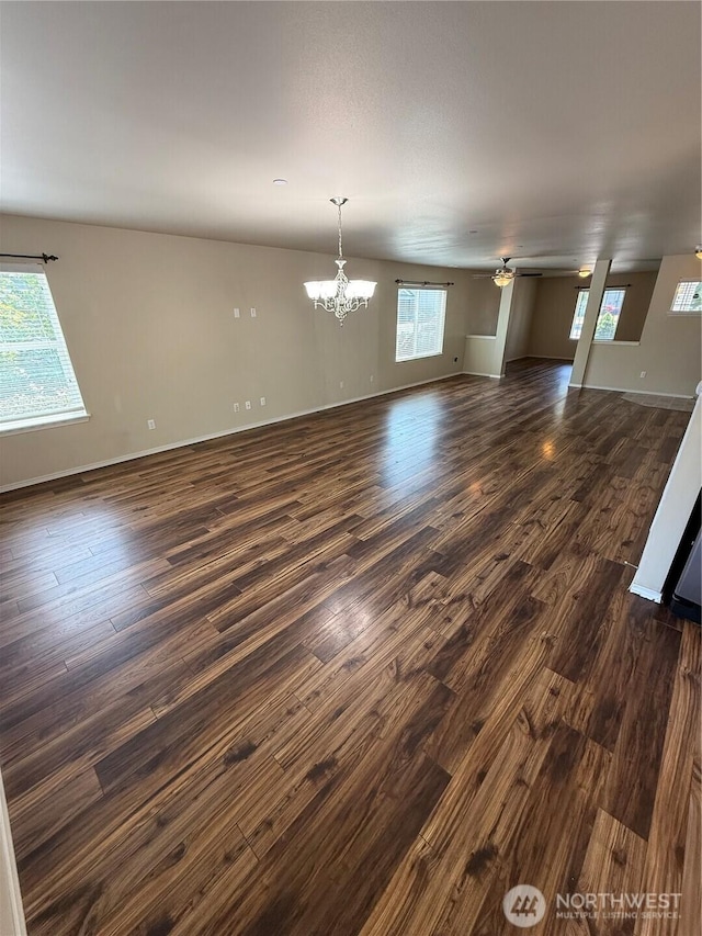 1306 Brackenridge Ave, Dupont, WA 98327 - unfurnished living room featuring dark wood-style floors, a chandelier, healthy amount of natural light, and a ceiling fan