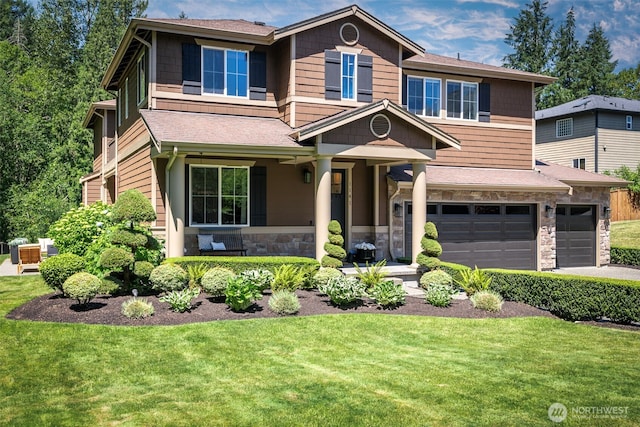 1141 Bell Hill Pl, Dupont, WA 98327 - view of front of home with stone siding, a garage, a front yard, and asphalt driveway