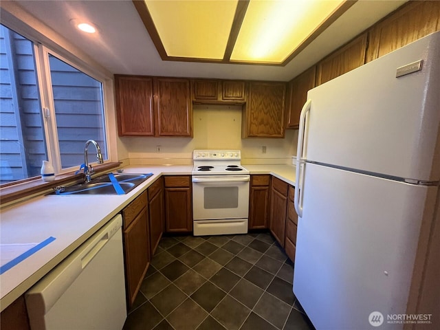 8407 18th Ave W Unit 4-103, Everett, WA 98204 - kitchen featuring white appliances, dark tile patterned flooring, light countertops, and brown cabinets