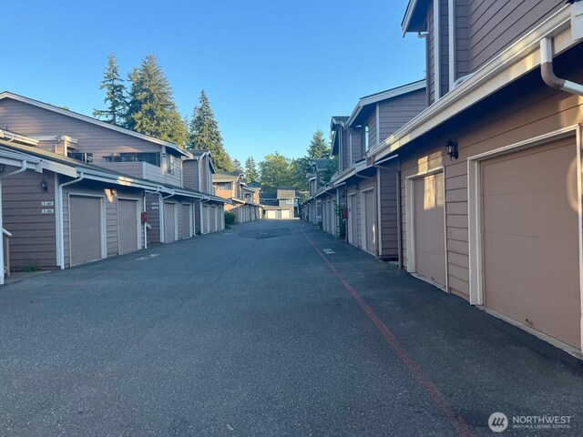 8407 18th Ave W Unit 4-103, Everett, WA 98204 - view of asphalt road featuring community garages and a residential view