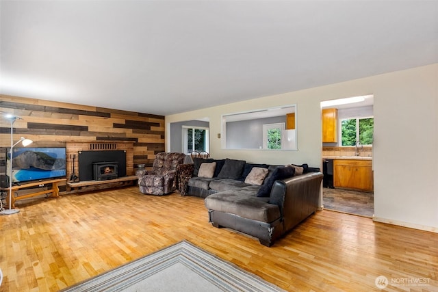 508 Ocean Beach Rd, Hoquiam, WA 98550 - living area featuring light wood-style floors, wooden walls, and a large fireplace