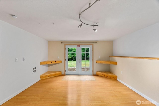 508 Ocean Beach Rd, Hoquiam, WA 98550 - unfurnished dining area featuring wood finished floors, french doors, and rail lighting
