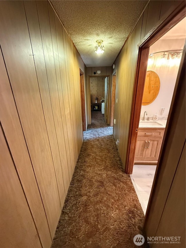 5645 Lento Pl SE, Olympia, WA 98513 - hall with light colored carpet, a textured ceiling, and wooden walls