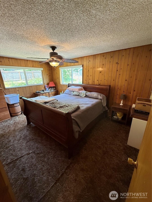 5645 Lento Pl SE, Olympia, WA 98513 - bedroom with a textured ceiling, dark colored carpet, wooden walls, and a ceiling fan