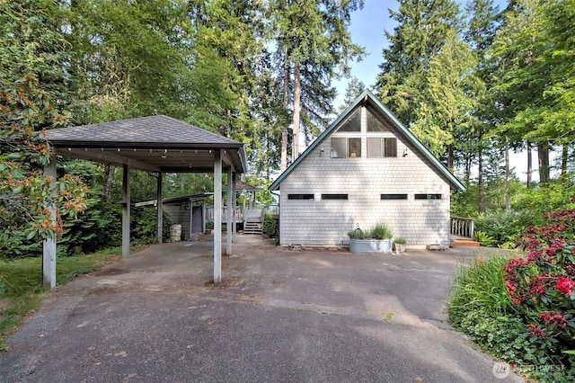 662 E Stadium Beach Rd E, Grapeview, WA 98546 - view of property exterior featuring asphalt driveway and roof with shingles