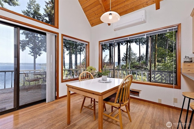 662 E Stadium Beach Rd E, Grapeview, WA 98546 - dining room featuring wood ceiling, light wood-style floors, a wall mounted AC, a water view, and high vaulted ceiling
