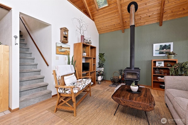 662 E Stadium Beach Rd E, Grapeview, WA 98546 - living room featuring a wood ceiling with exposed beams, a wood stove, wood finished floors, stairway, and high vaulted ceiling