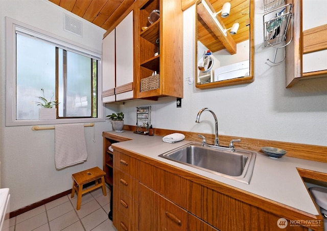 662 E Stadium Beach Rd E, Grapeview, WA 98546 - kitchen with light countertops, light tile patterned floors, wood ceiling, and open shelves