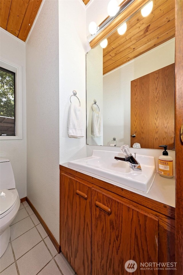 662 E Stadium Beach Rd E, Grapeview, WA 98546 - half bathroom featuring wood ceiling, vanity, and tile patterned floors
