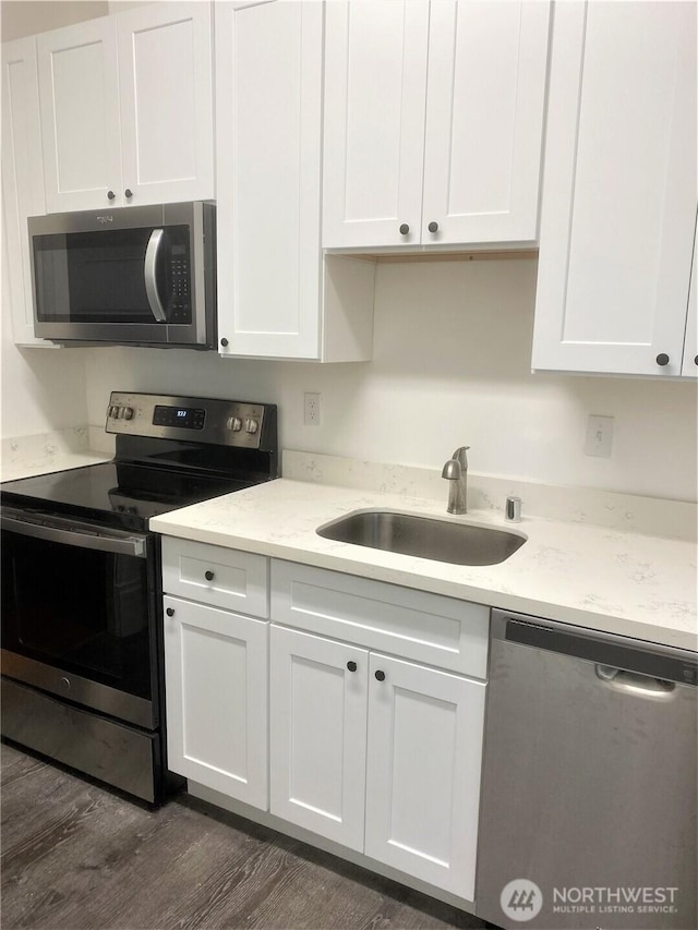 3722 Oakes Ave, Everett, WA 98201 - kitchen with appliances with stainless steel finishes, white cabinets, dark wood finished floors, and light stone counters