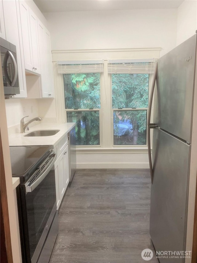 3722 Oakes Ave, Everett, WA 98201 - kitchen featuring appliances with stainless steel finishes, dark wood-style floors, white cabinetry, light countertops, and plenty of natural light