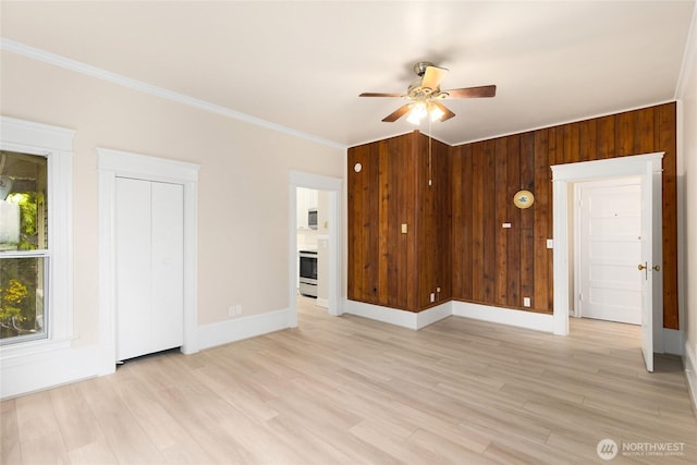 3722 Oakes Ave, Everett, WA 98201 - unfurnished living room with ceiling fan, ornamental molding, light wood-style floors, and wood walls