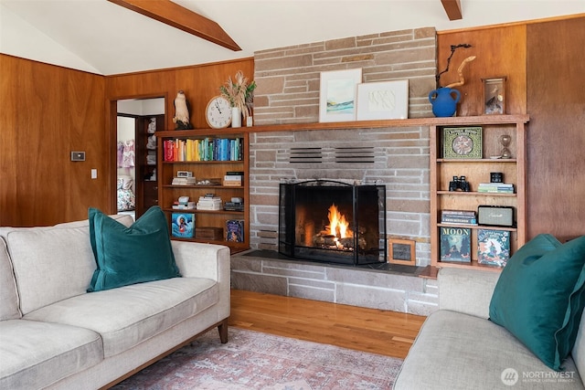 16305 Crescent Dr SW, Vashon, WA 98070 - living area featuring a stone fireplace, lofted ceiling, wood finished floors, and wood walls