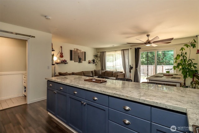 6530 Newaukum Pl NE, Bremerton, WA 98311 - kitchen with open floor plan, blue cabinets, dark wood-type flooring, a ceiling fan, and healthy amount of natural light