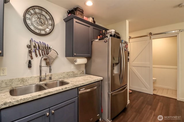 6530 Newaukum Pl NE, Bremerton, WA 98311 - kitchen featuring stainless steel appliances, a barn door, dark wood-style floors, light stone counters, and gray cabinets