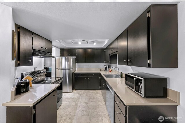 1211 N 8th St Unit 2, Mount Vernon, WA 98273 - kitchen with appliances with stainless steel finishes, under cabinet range hood, light countertops, and a tray ceiling