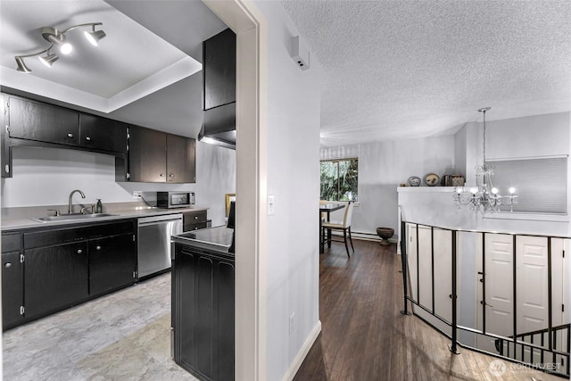 1211 N 8th St Unit 2, Mount Vernon, WA 98273 - kitchen featuring stainless steel appliances, a chandelier, a textured ceiling, dark cabinets, and light countertops